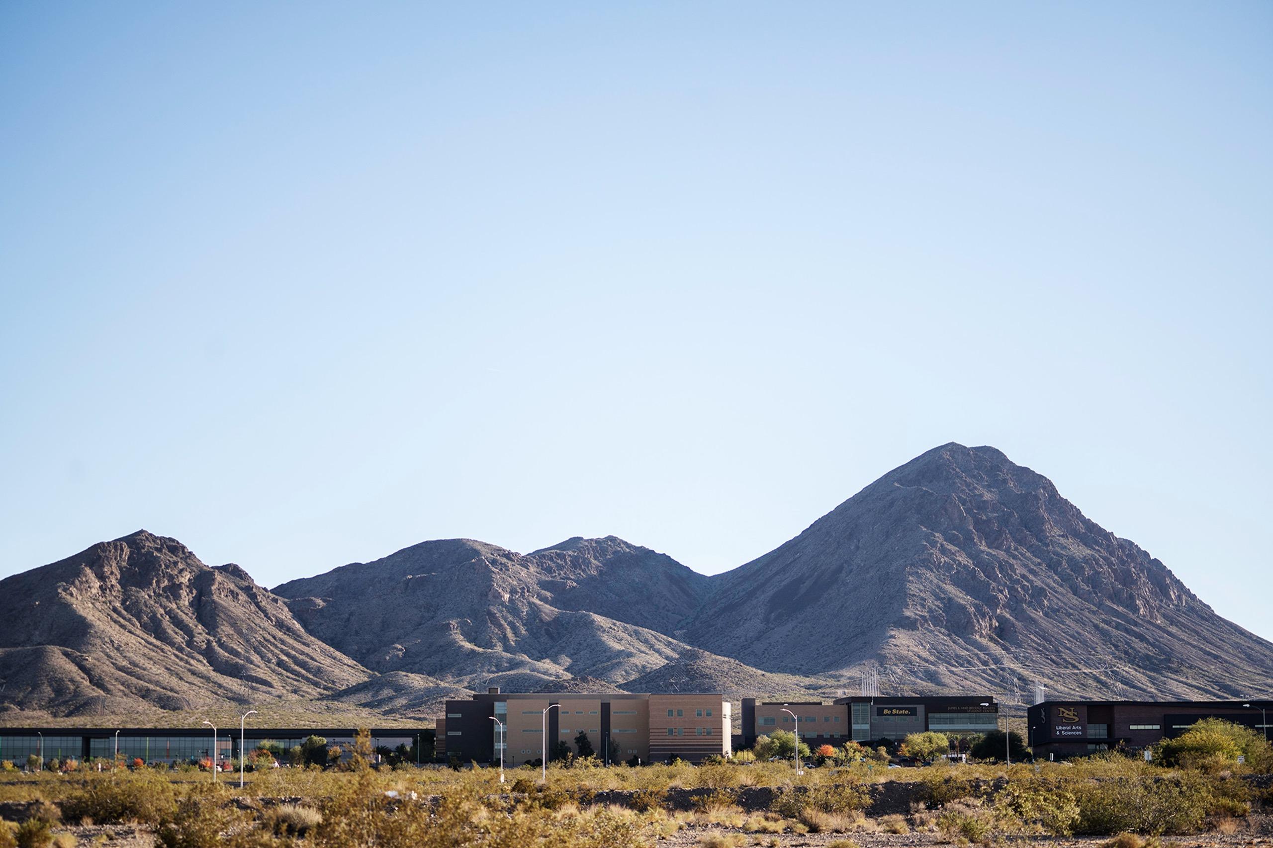 Nevada State's training environment featuring the distinctive Henderson mountain range with university buildings visible at the base, highlighting the inspiring natural surroundings where Scorpion athletes train