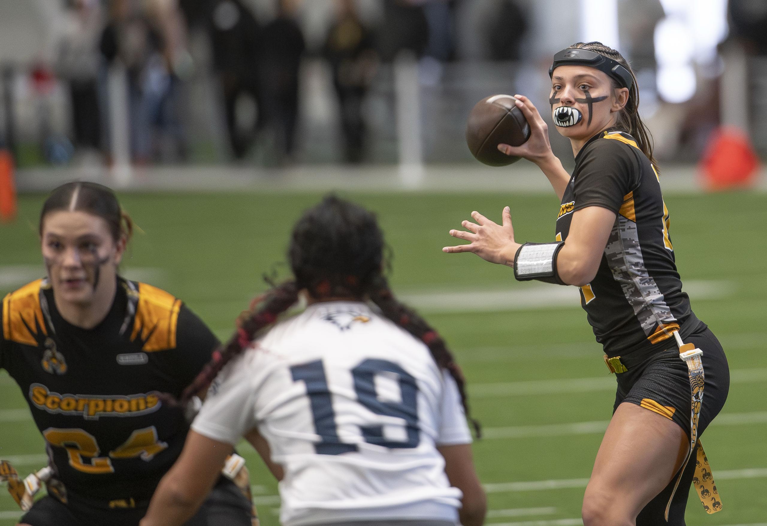 Nevada State University flag football quarterback drops back for a pass against La Sierra University